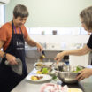 Two volunteers working in a CatholicCare Kitchen.
